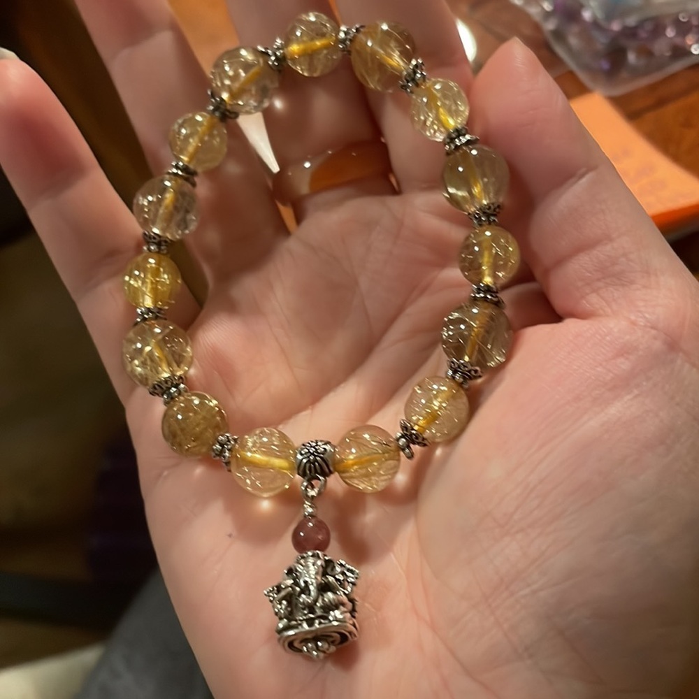 Gold rutilated quartz with a lucky charm bracelet